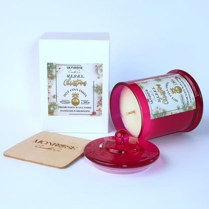 "Side view of a red jar candle with 
"Hot Cinnamon" fragrance and a cotton wick, containing 380 grams of soy wax and offering 60 hours of burn time."