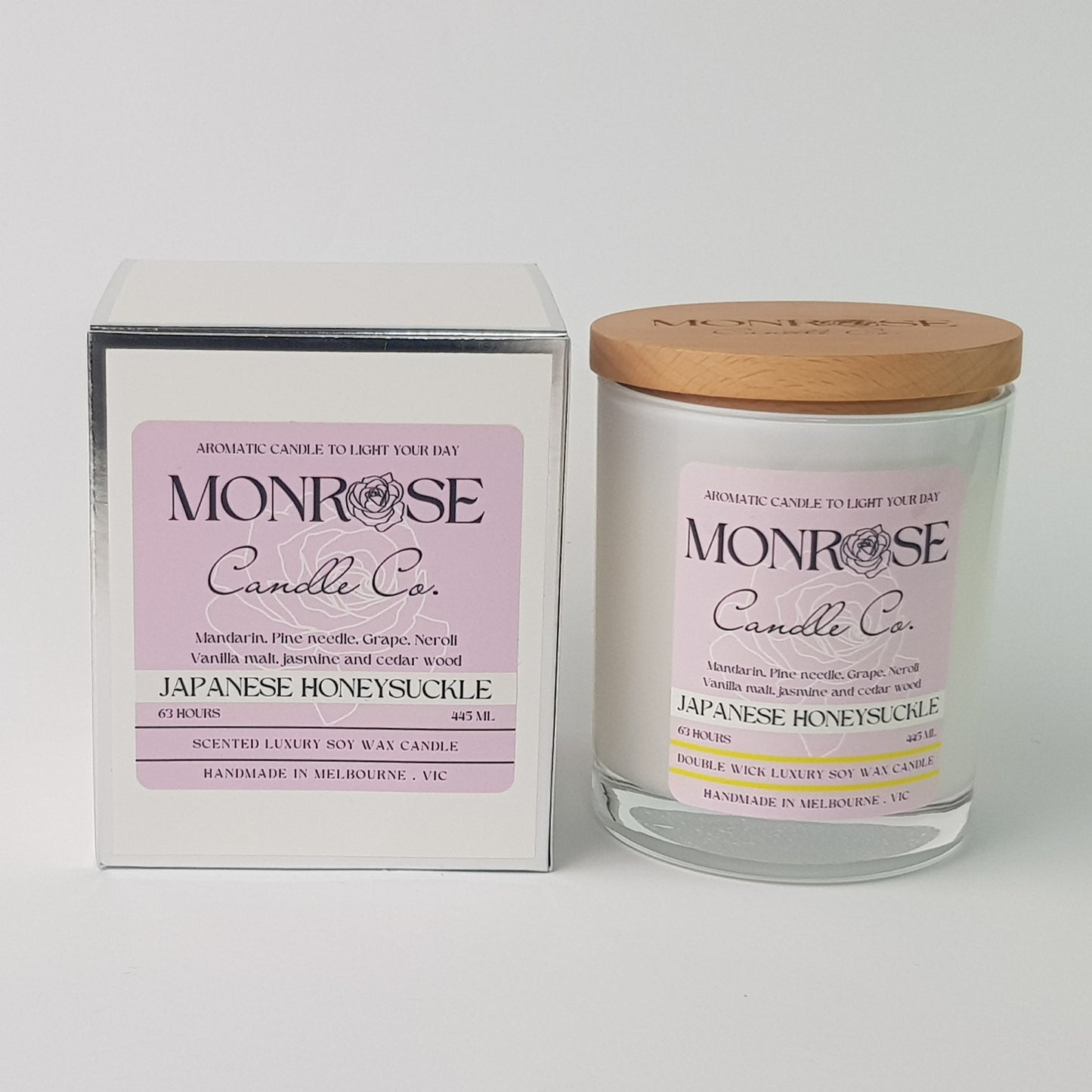 Front view of a white jar candle with "Japanese honeysuckle" fragrance and a cotton wick, containing 395 grams of soy wax and offering 63 hours of burn time.