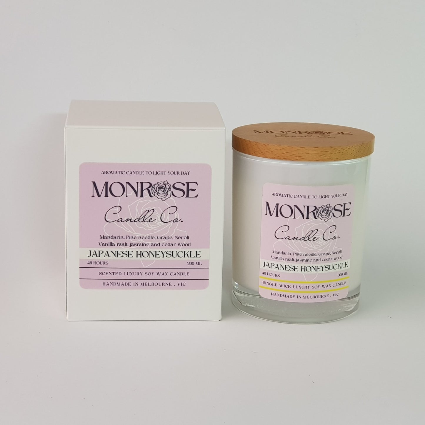 Front view of a white jar candle with "Japanese honeysuckle" fragrance and a cotton wick, containing 265 grams of soy wax and offering 48 hours of burn time.