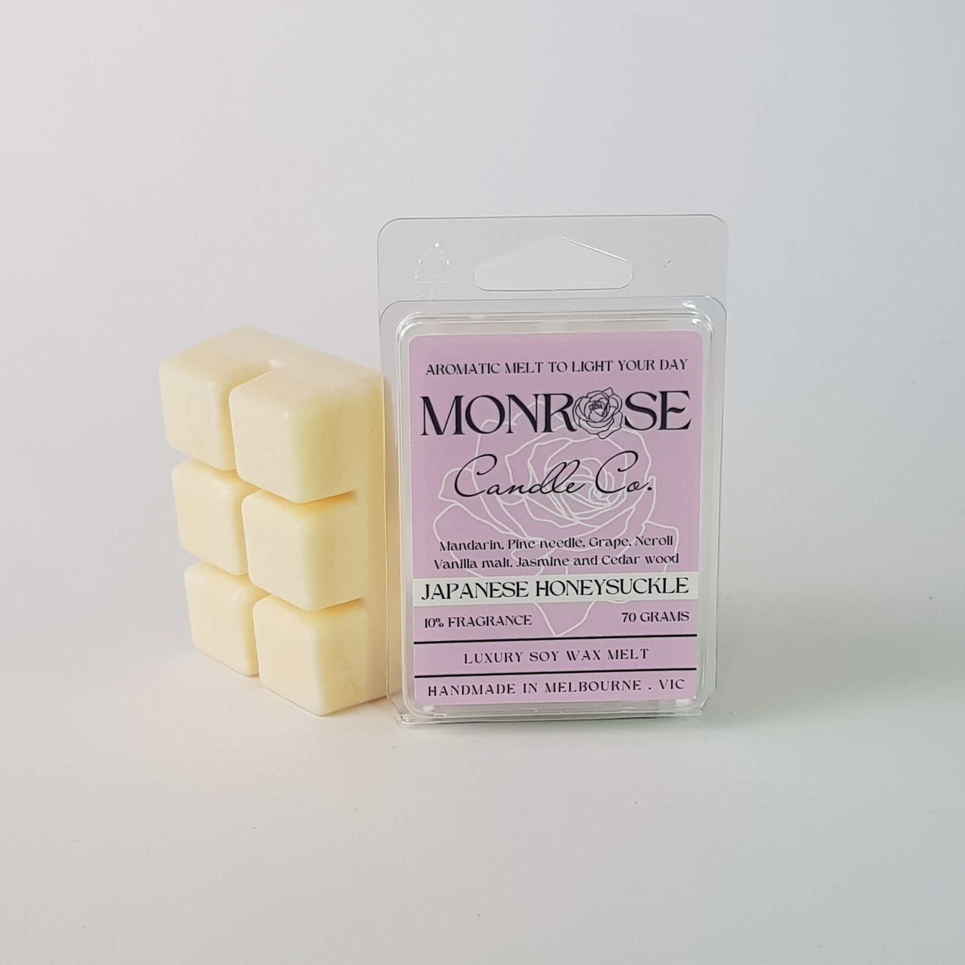 "This is the side view of a 6 pack soy wax melt, featuring a cream solid wax melt standing on the left of the packaging. The fragrance of the wax melt is Japanese honeysuckle and contains 70 grams of soy wax and it is hand crafted in Melbourne, Australia."