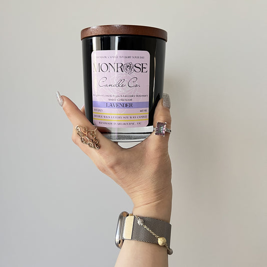 Front view of a black jar candle collection with "Lavender" fragrance and cotton wick.