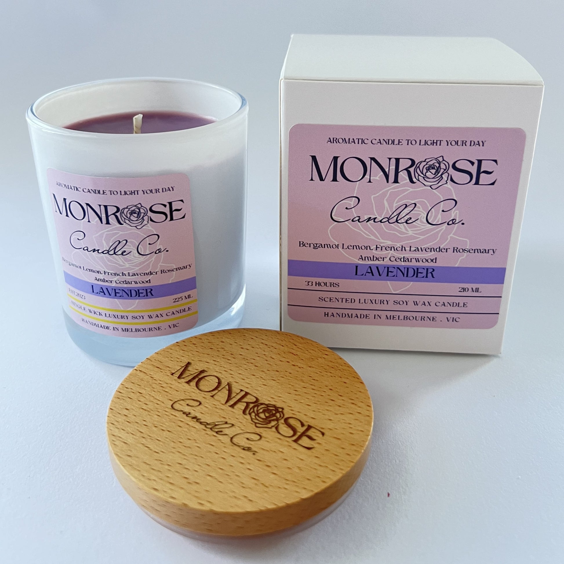 Side view of a white jar candle with "Lavender" fragrance and double cotton wicks, containing 185 grams of soy wax and offering 33 hours of burn time.
