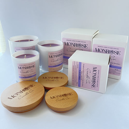 Front view of white jar candle collection with "Lavender" fragrance and cotton wicks.
