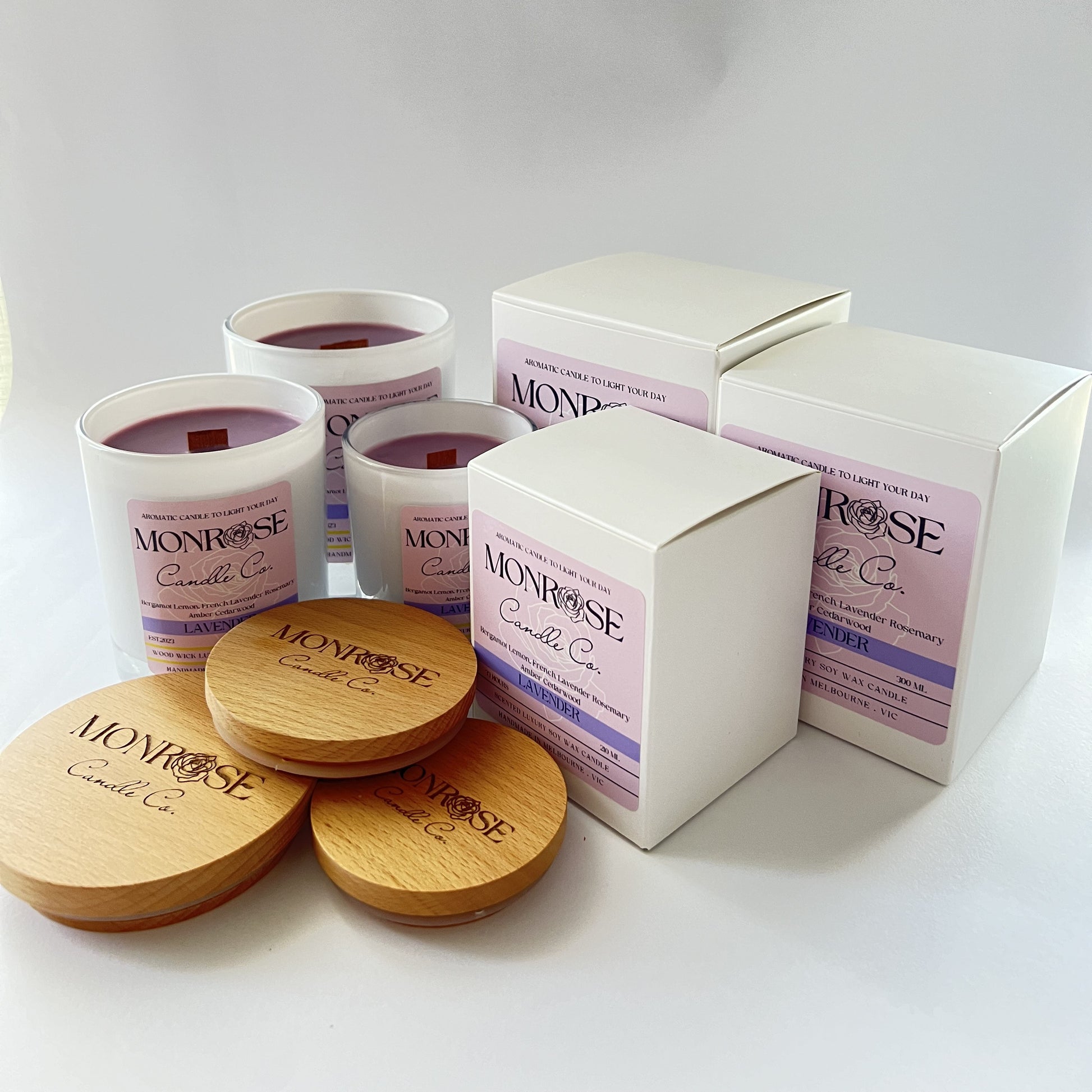 Front view of a white jar candle collection with "Lavender" fragrance and wood wicks.
