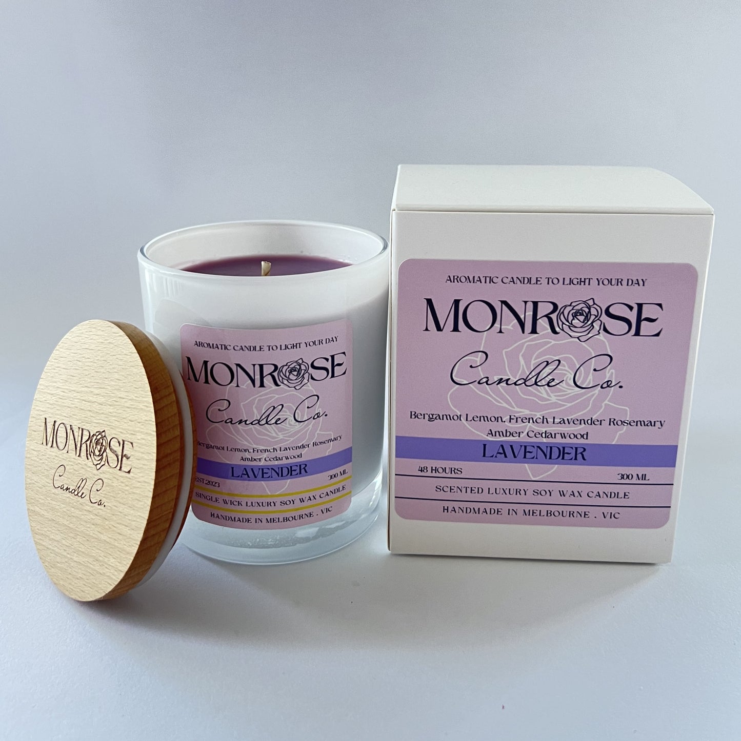 Side view of a white jar candle with "Lavender" fragrance and double cotton wicks, containing 265 grams of soy wax and offering 48 hours of burn time.
