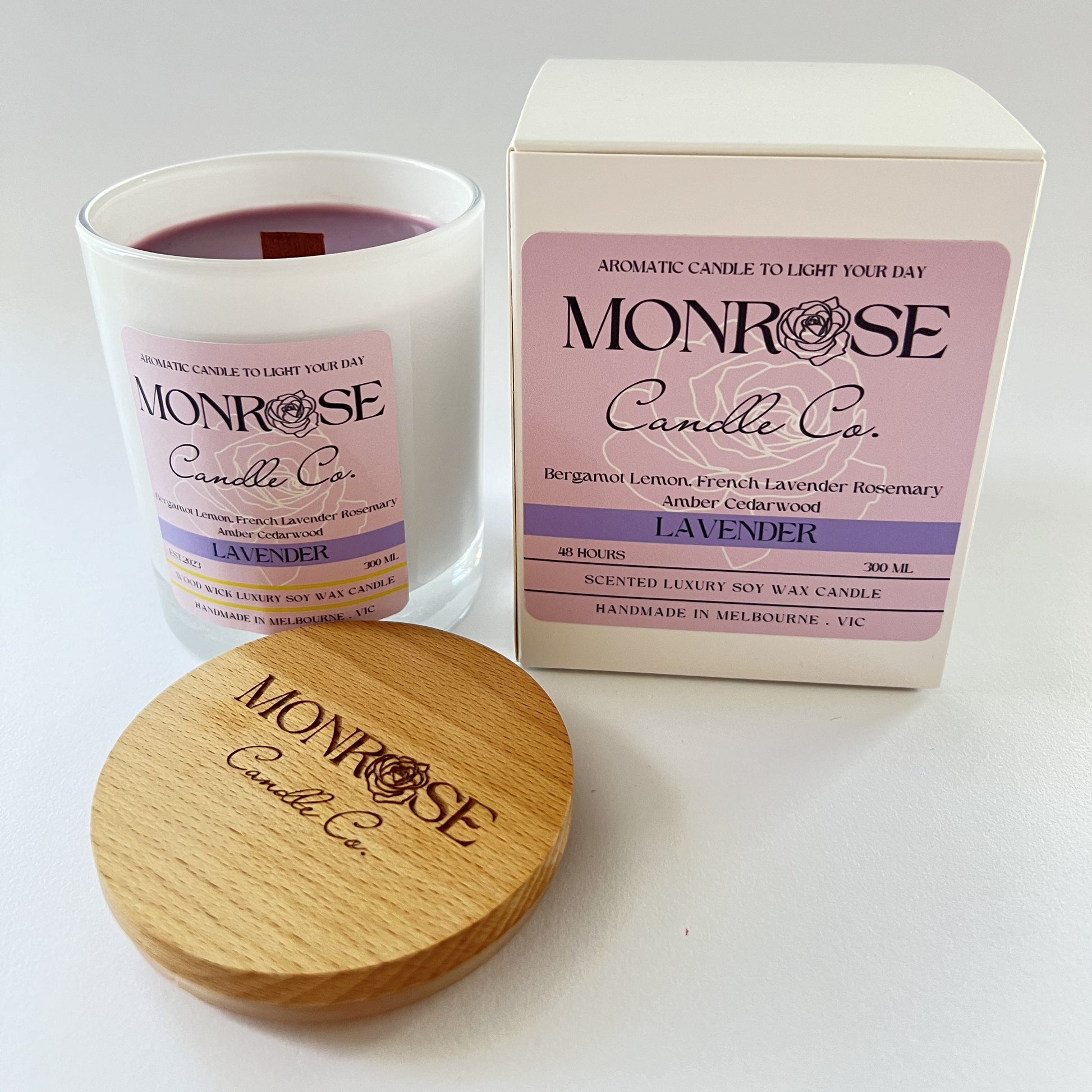 Front view of a white jar candle with "Lavender" fragrance and a wood wick, containing 265 grams of soy wax and offering 48 hours of burn time.
