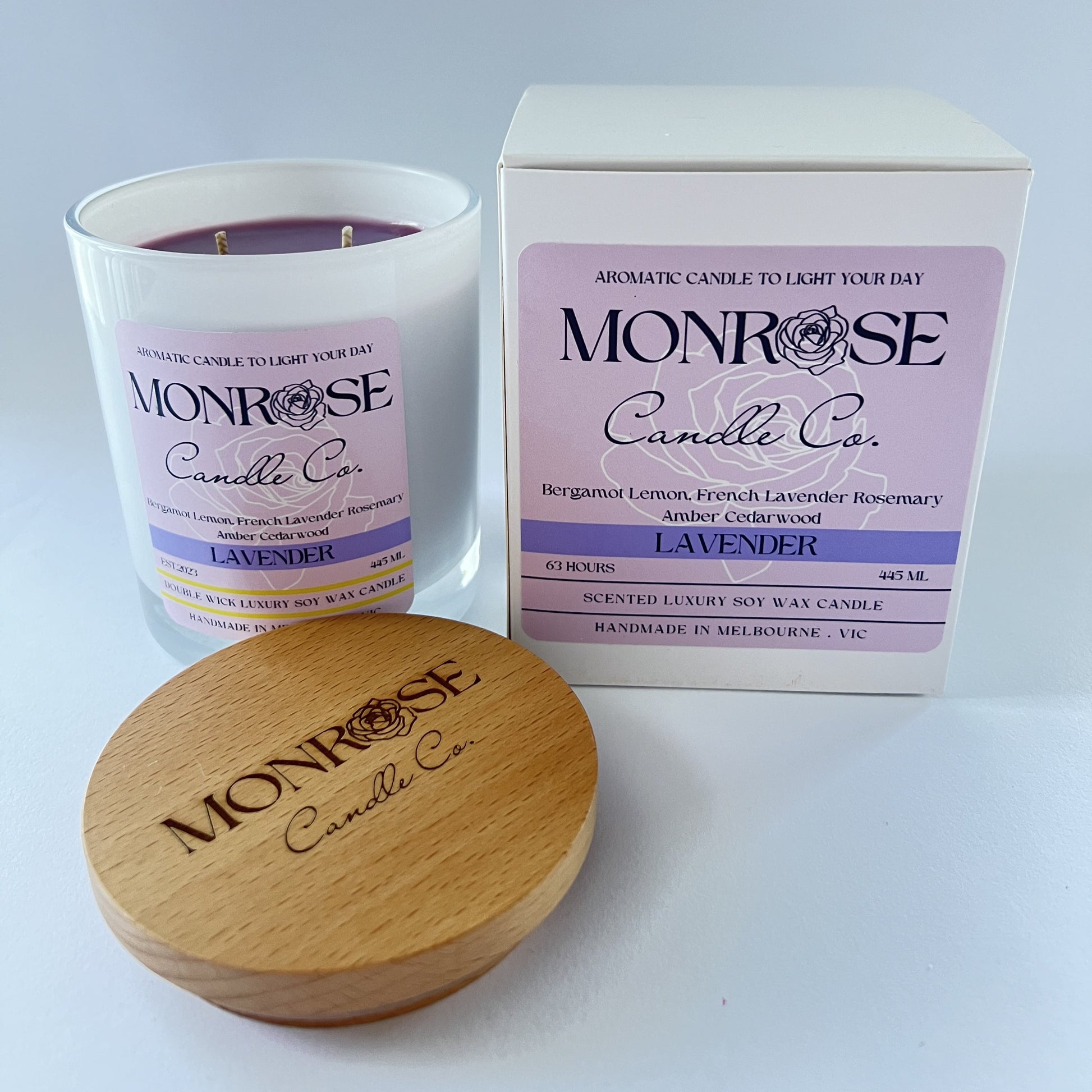 Side view of a black jar candle with "Lavender fragrance" and double cotton wicks, containing 395 grams of soy wax and offering 63 hours of burn time.