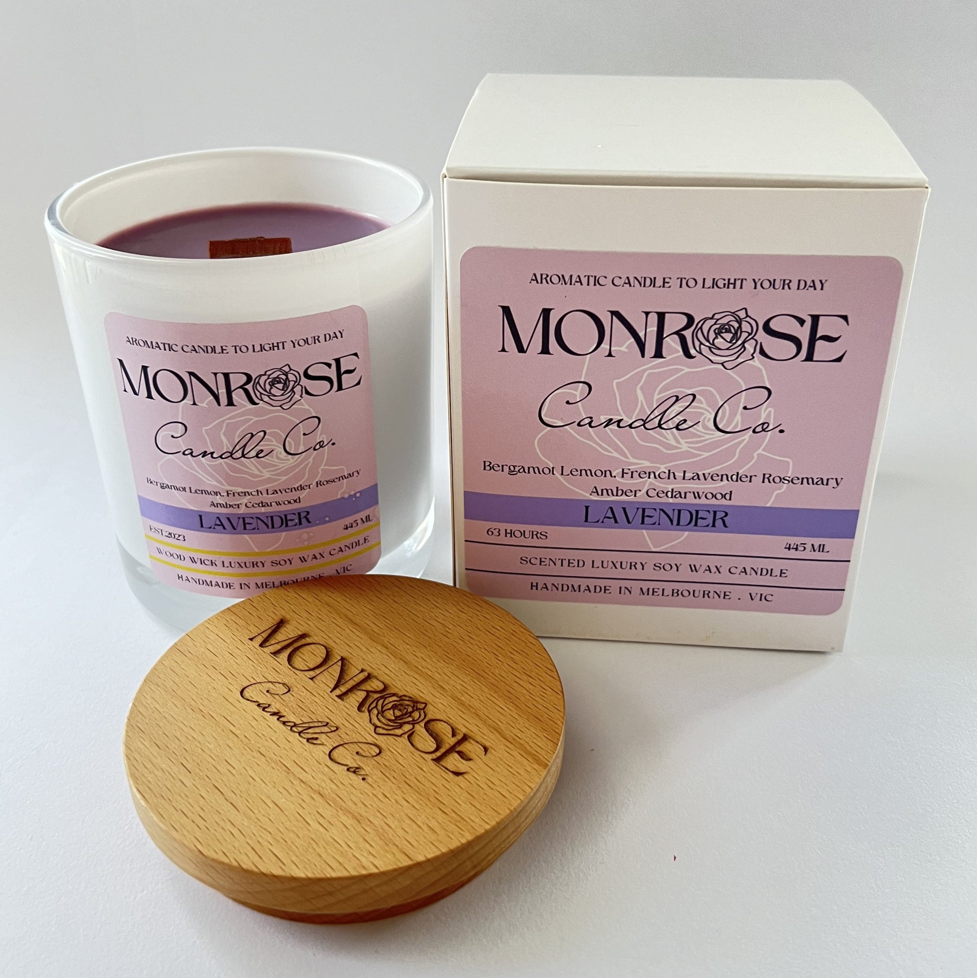 Side view of a white jar candle with "Lavender" fragrance and wood wicks, containing 395 grams of soy wax and offering 63 hours of burn time.