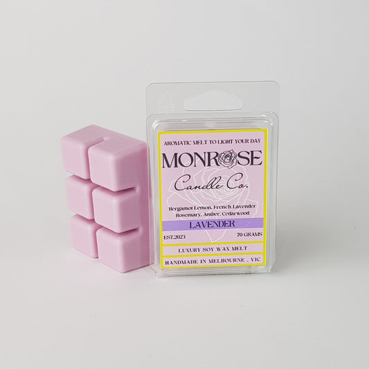 This is the side view of a 6 pack soy wax melt, featuring a purple solid wax melt standing on the left of the packaging. The fragrance of the wax melt is "Lavender" and contains 70 grams of soy wax and it is hand crafted in Melbourne, Australia.
