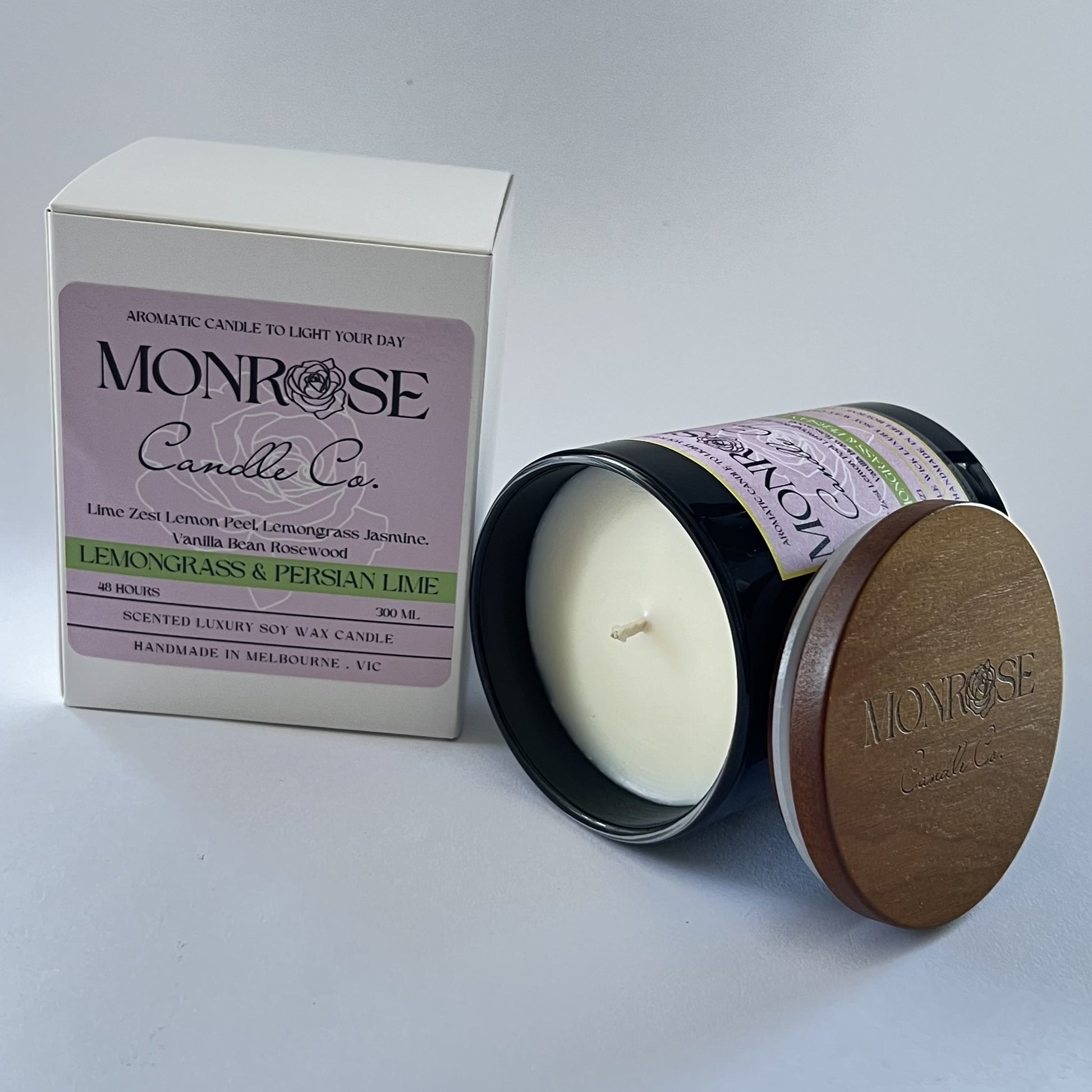 Side view of a black jar candle with "Lemongrass & Persian lime" fragrance and a cotton wick, containing 265 grams of soy wax and offering 48 hours of burn time.
