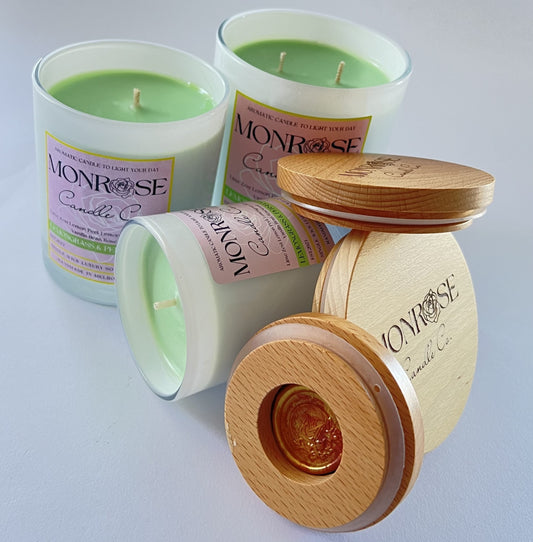 Front view of scented candle collection in white jars infused with "Lemongrass & Persian lime" fragrance and cotton wicks.
