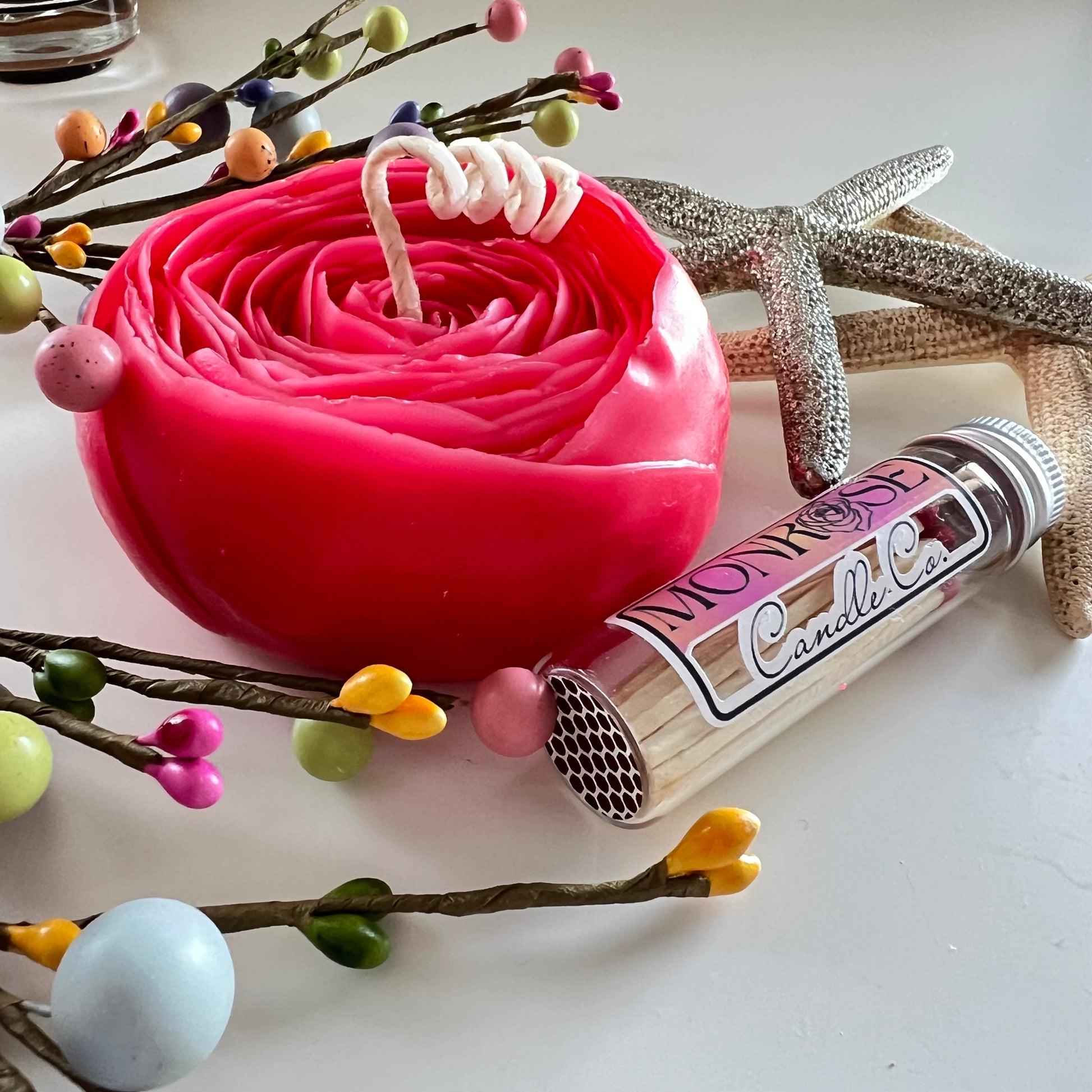 Side view of English Rose Floating Candle No.5 with "Lychee Peony" fragrance and cotton wick beside a match jar, containing 165 grams of soy wax and offering 11 hours of burn time.