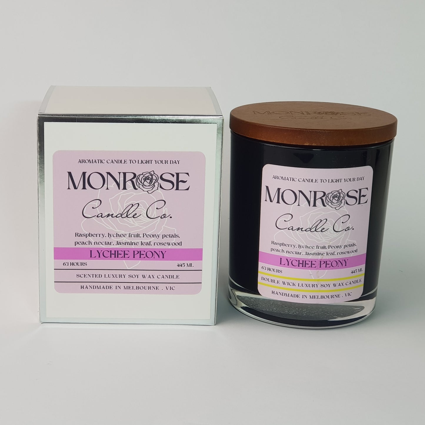 Front view of a black jar candle with "Lychee peony" fragrance and double cotton wicks, containing 395 grams of soy wax and offering 63 hours of burn time.