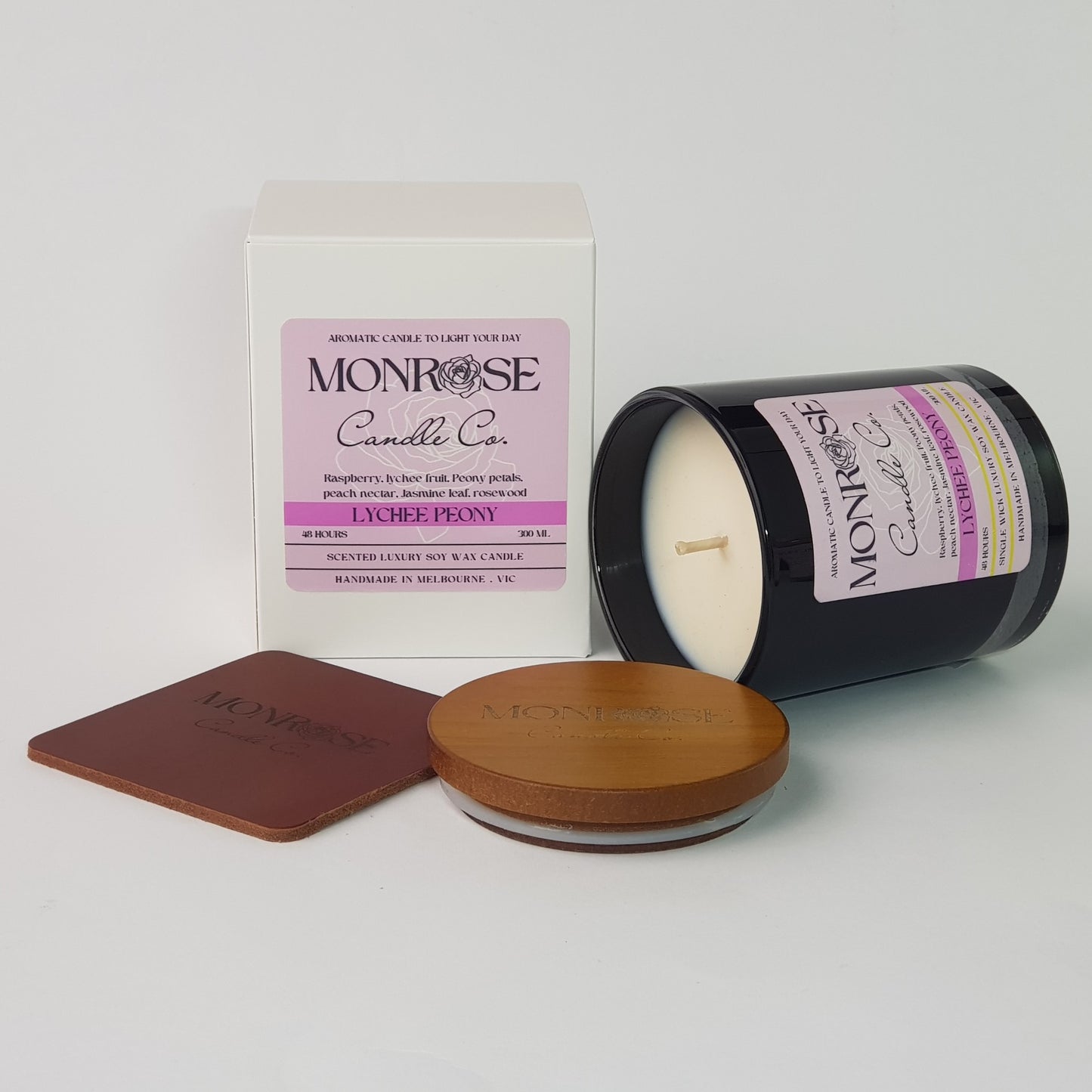 Front view of a white jar candle with "Lychee peony" fragrance and a cotton wick, containing 265 grams of soy wax and offering 48 hours of burn time.