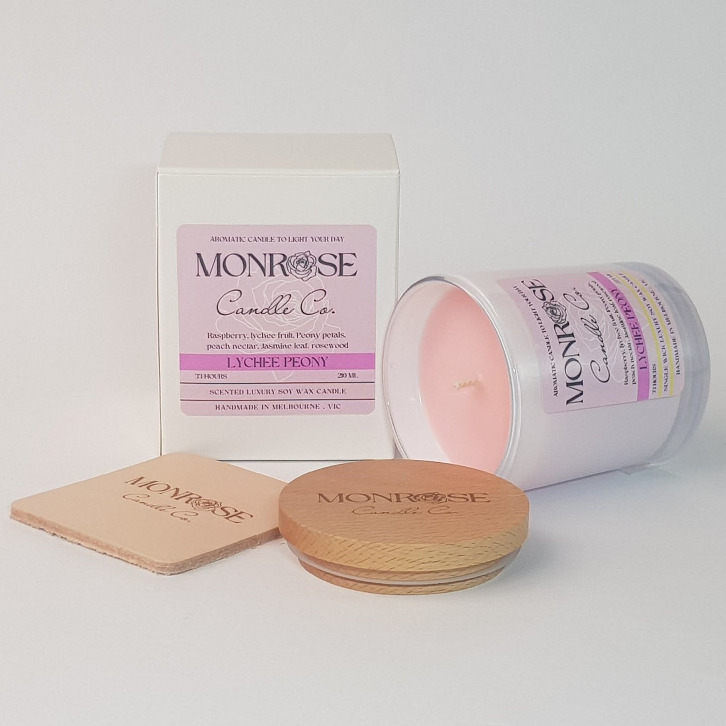 Side view of a white jar candle with "Lychee peony" fragrance and a cotton wick, containing 185 grams of soy wax and offering 33 hours of burn time.
