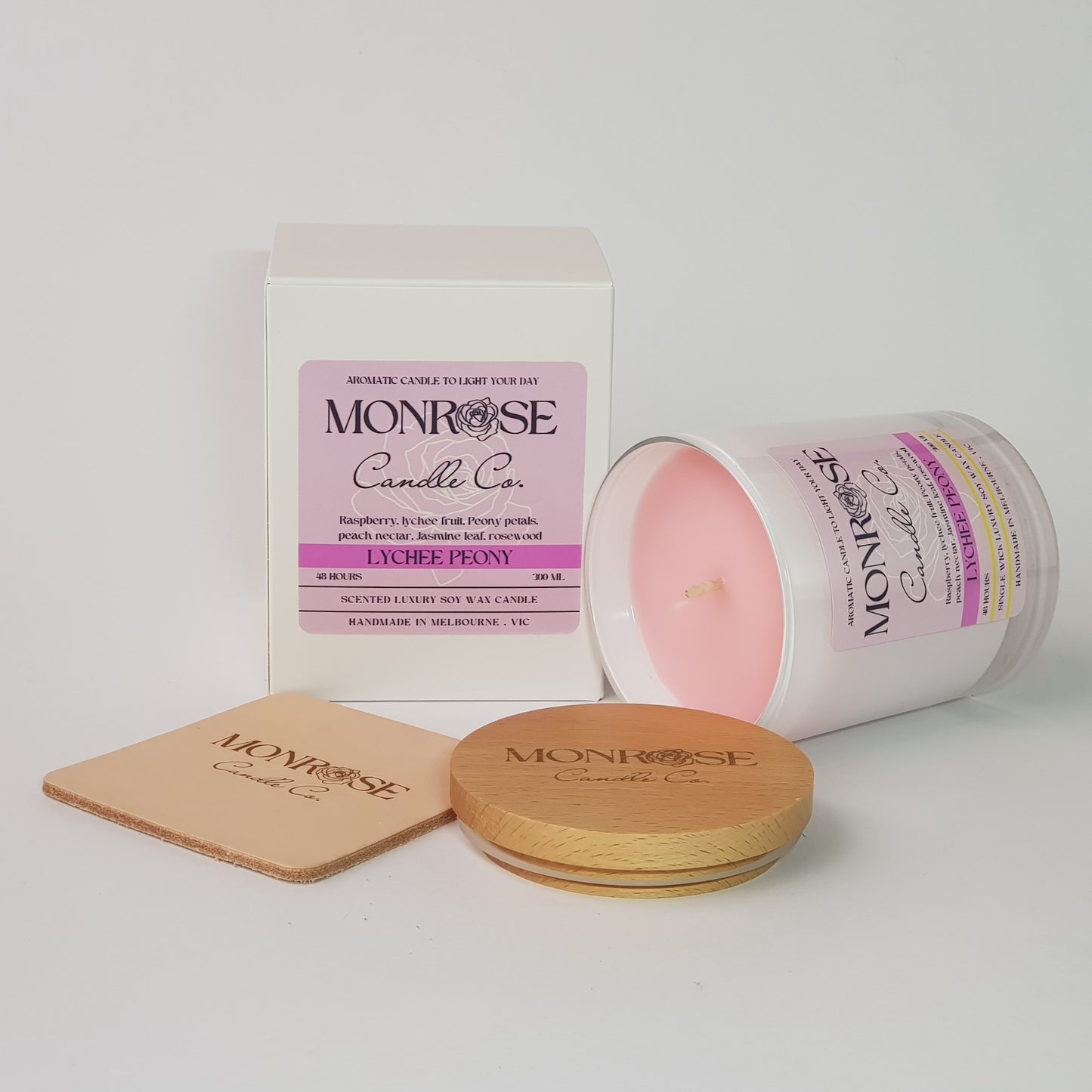 Side view of a white jar candle with "Lychee peony" fragrance and a cotton wick, containing 265 grams of soy wax and offering 48 hours of burn time.
