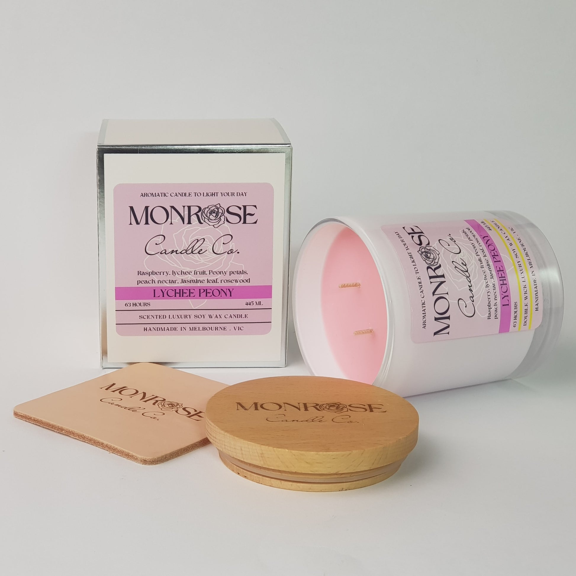 Side view of a white jar candle with "Lychee Peony" fragrance and double cotton wicks, containing 395 grams of soy wax and offering 63 hours of burn time.