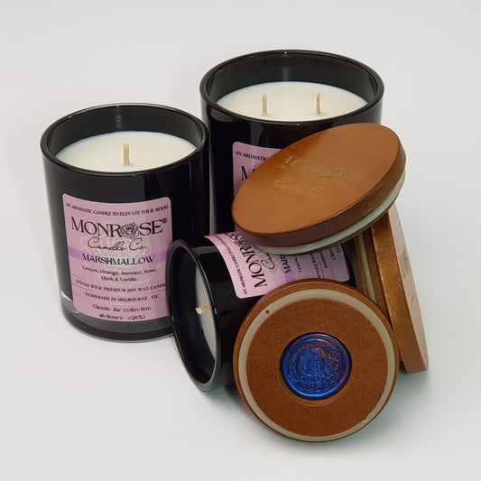 Front view of the black jar candle collection with "Marshmallow" fragrance and cotton wicks.