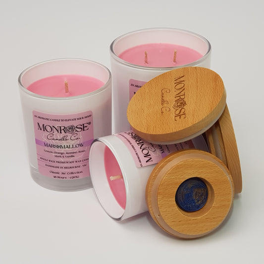 Front view of the white jar candle collection with "Marshmallow" fragrance and cotton wicks.