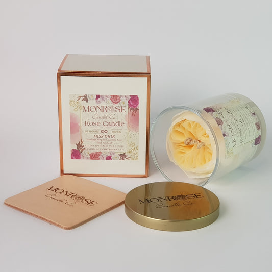 Side view of a Rose Candle No.6 in a clear jar with "Miss Dior" fragrance and a cotton wick, containing 365 grams of bees & soy wax and offering 56 hours of burn time.