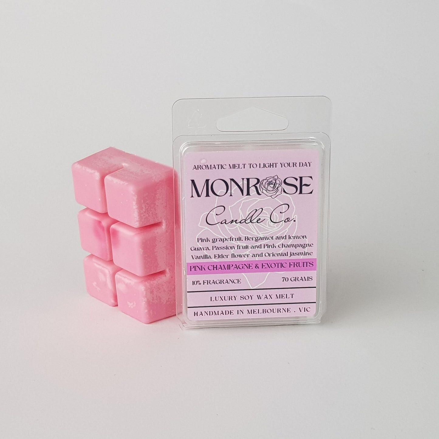 This is the side view of a 6 pack soy wax melt, featuring a pink solid wax melt standing on the left of the packaging. The fragrance of the wax melt is "Pink champagne and exotic fruits" and contains 70 grams of soy wax and it is hand crafted in Melbourne, Australia.