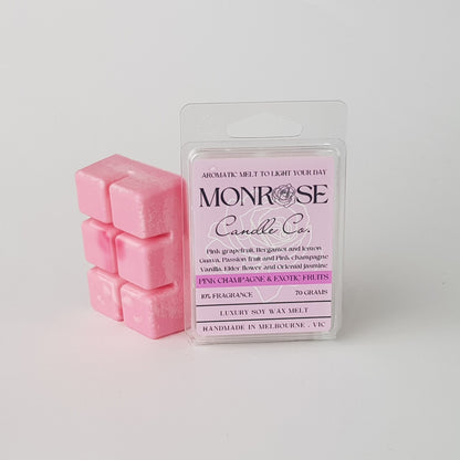 This is the side view of a 6 pack soy wax melt, featuring a pink solid wax melt standing on the left of the packaging. The fragrance of the wax melt is "Pink champagne and exotic fruits" and contains 70 grams of soy wax and it is hand crafted in Melbourne, Australia.