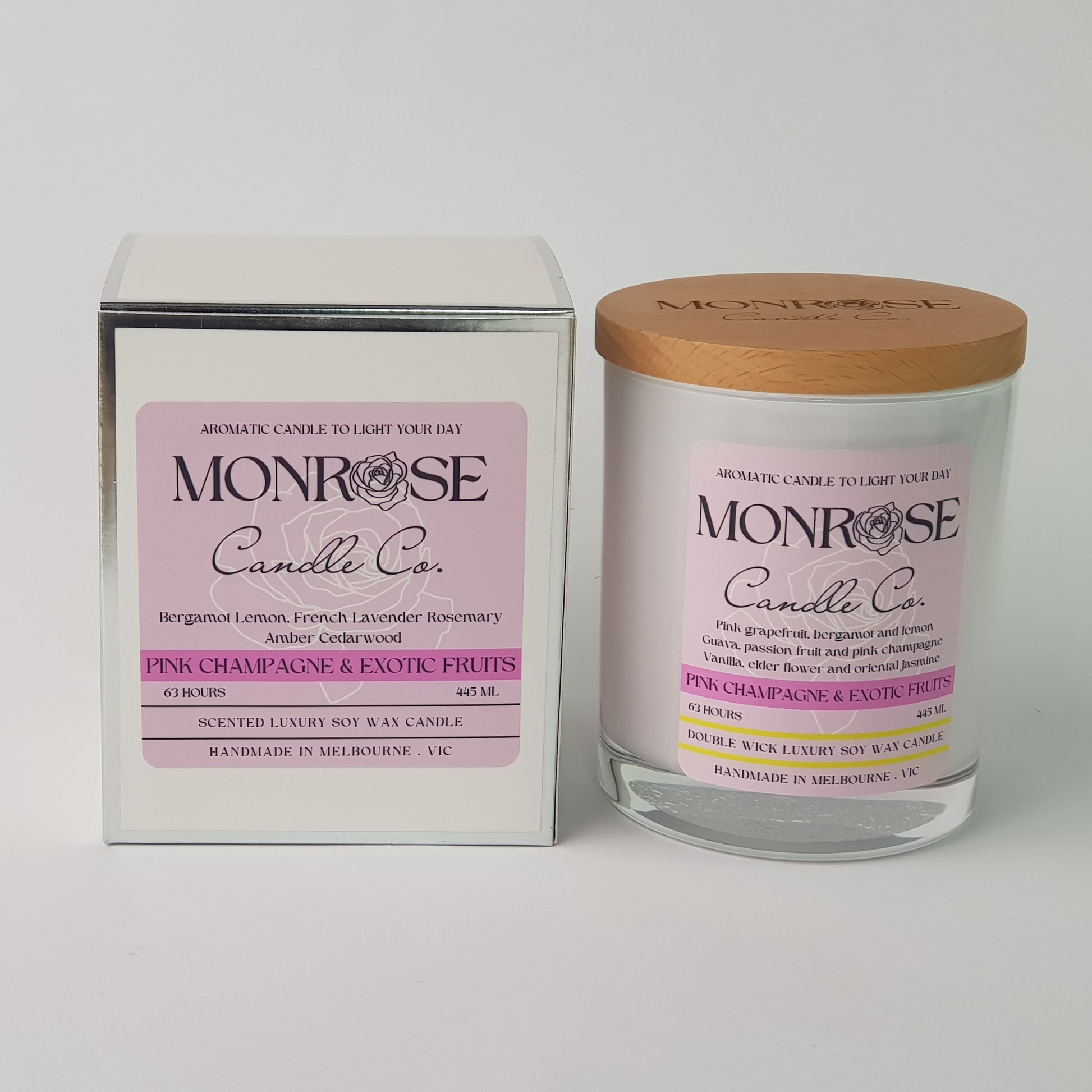 Front view of a white jar candle with "pink champagne and exotic fruits" fragrance and a cotton wick, containing 395 grams of soy wax and offering 63 hours of burn time."