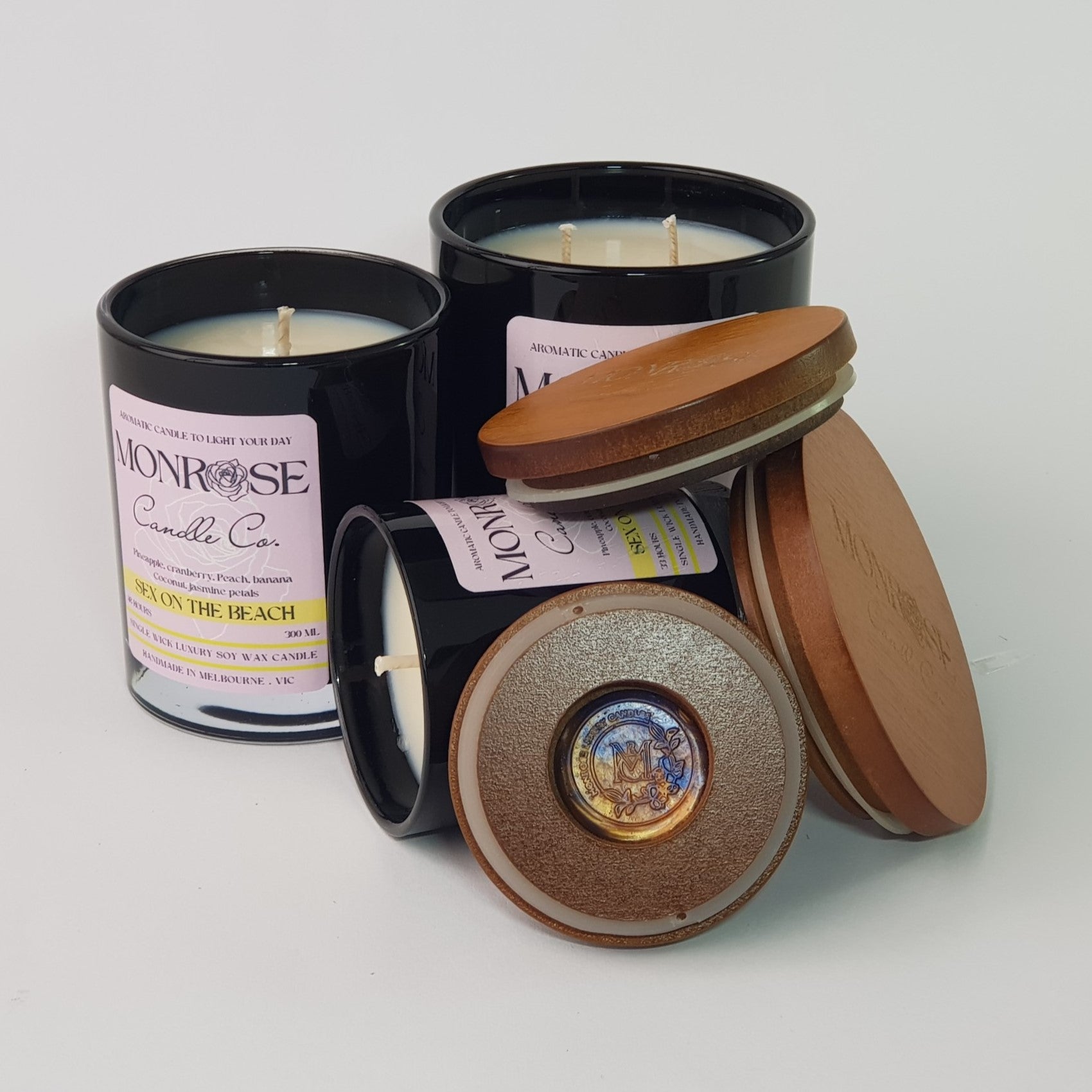 Front view of "Sex on the beach" candle collection in black jars with and  cotton wicks.