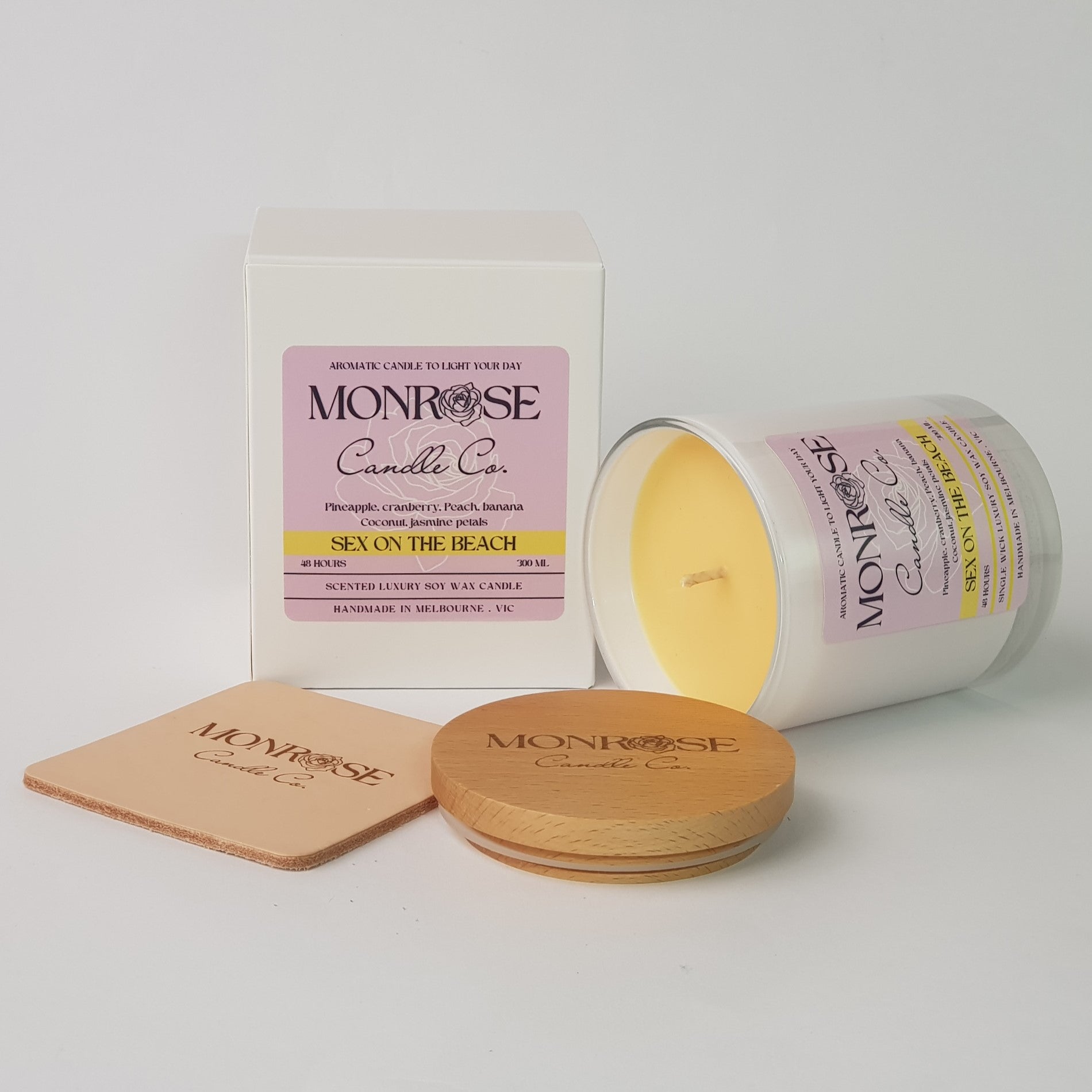 "Side view of a white jar candle with "sex on the beach" fragrance and a cotton wick, containing 265 grams of soy wax and offering 48 hours of burn time."