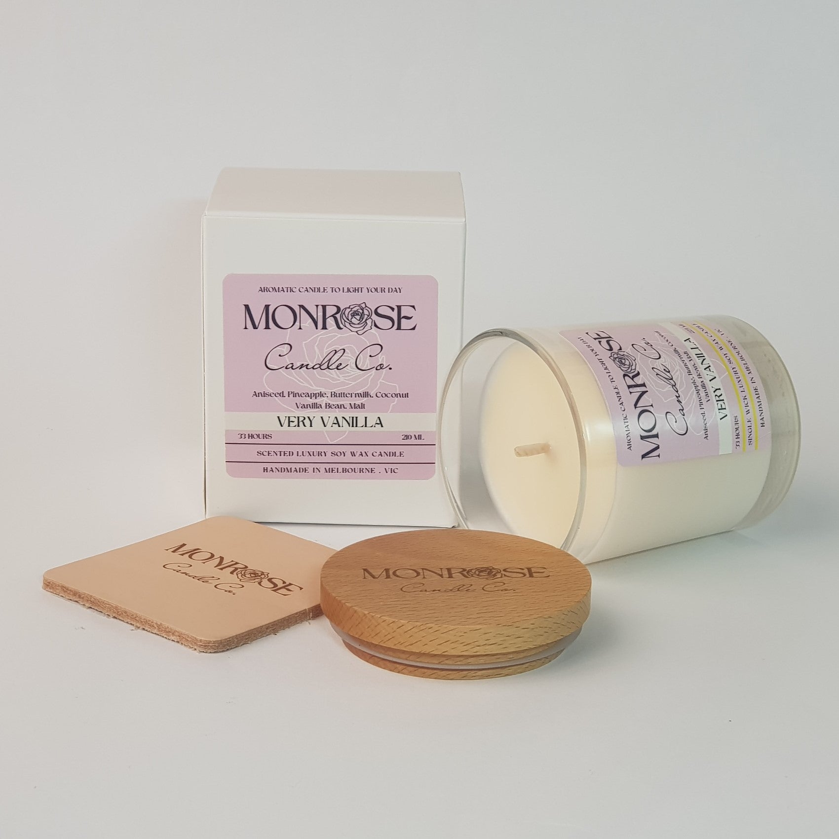 Side view of a clear jar candle with "very vanilla" fragrance and a cotton wick, containing 185 grams of soy wax and offering 33 hours of burn time.